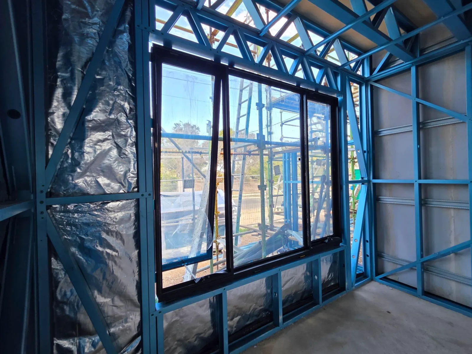 Interior view through a newly installed aluminium sliding window during construction in Clearview, Adelaide